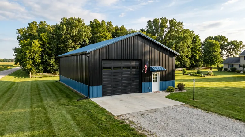Residential pole barn shop with black siding and blue wainscoting